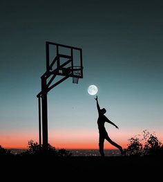 the silhouette of a person reaching for a basketball in front of a basket ball hoop