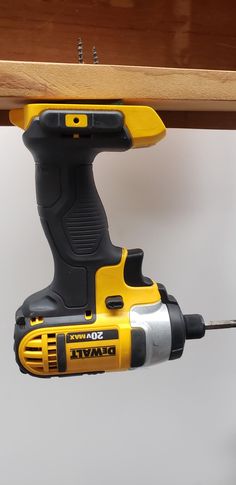 a cordless drill is attached to a shelf