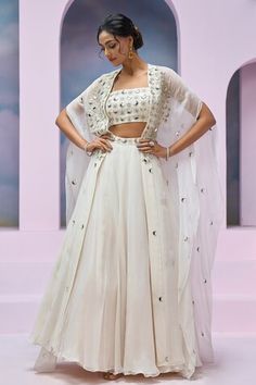 Ivory cape with mirror and nalki embroidery. Comes with coordinating blouse and embroidered waistband lehenga. - Aza Fashions Ivory Mirror, Mirror Blouse, Cape Lehenga, Lehenga Pattern, Long Drapes, Organza Blouse, Blouse Sleeveless, Draped Fabric, Set For Women