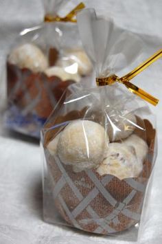 two bags filled with cookies sitting on top of a table