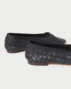 Ballet flat in black woven leather. Features a slightly elongated, almond-shaped toe and a padded footbed. Slips on. Chic Woven Leather Flats With Round Toe, Black Woven Leather Slip-on Loafers, Black Woven Leather Loafers With Round Toe, Formal Black Loafers With Woven Sole, Woven Leather Slip-on Loafers With Flat Heel, Elegant Woven Leather Closed Toe Flats, Flat Leather Loafers With Woven Sole, Leather Loafers With Woven Sole, Woven Leather Almond Toe Loafers