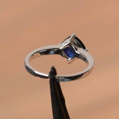 It is a lab sapphire ring. The main stone is 7 mm*7 mm cushion cut.weight about 1.94 carats. The basic metal is sterling silver and plated with rhodium. To change the metal to a solid gold (white/rose) or platinum is also available, please ask for a quotation if you want. You can also go to my shop Home for more elegant rings: https://www.etsy.com/shop/godjewelry?ref=hdr_shop_menu Sapphire is the September birthstone. More sapphire rings: https://www.etsy.com/shop/godjewelry?section_id=20715031 Cushion Cut Sapphire Sterling Silver Jewelry, Classic Silver Birthstone Ring With Lab-created Sapphire, Classic Silver Sapphire Ring With Lab-created Sapphire, Sapphire Sterling Silver Birthstone Ring, Round Cut, Elegant Square-cut Sapphire Ring In Sterling Silver, Blue Engagement Ring, Sapphire Wedding, Sapphire Engagement Ring Blue, Birthstone