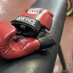 a pair of boxing gloves sitting on top of a bench