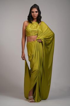 Mustard green pre-draped saree with pearl, sequin embroidery on waistband. Paired with geometric embroidered padded blouse.
Components: 2
Pattern: Embroidery
Type Of Work: Pearl, sequin
Neckline: Round
Sleeve Type: Sleeveless
Fabric: Saree: Modal Satin, Blouse: Silk
Color: Green
Other Details: 
Back deep U neck blouse
Approx weight: 5-7 kgs
Model height: 5ft 9inches, wearing size M
Occasion: Sangeet - Aza Fashions U Neck Blouse, Pearl Saree, Indian Dress Up, Satin Embroidery, Draped Saree, Mustard Green, Padded Blouse, Drape Saree, Blouse Silk