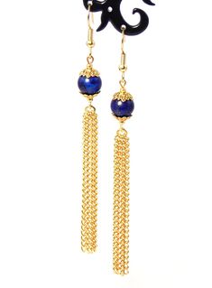 Clip-on style also available! Semi precious Lapis Lazuli stones coupled with gold tones give these tassel chain earrings a classy chic look while still making a statement! Earrings are lightweight making them very wearable! Earring hooks are 22k gold plated hypoallergenic and will help to avoid irritating the ears. Product Details .Semi precious Lapis Lazuli stones. .Antique gold plated bead caps. .Gold finished steel chain. .22k gold plated jump rings & head pins. .22k gold plated hypoaller Elegant Blue Chandelier Earrings With Latkans, Elegant Dangle Tassel Jewelry, Elegant Metal Tassel Earrings, Elegant Metal Jewelry With Tassels, Elegant Metal Tassel Jewelry, Adjustable Chain Dangle Earrings For Evening, Elegant Metal Dangle Tassel Earrings, Evening Dangle Earrings With Adjustable Chain, Elegant Metal Tassel Drop Earrings