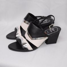 These Roger Vivier Sandals Are Finely Crafted In A Combination Of Black And Cream Leather, Featuring A Slingback, Open-Toe Style. This Is Your Go-To Pair To Wear To The Boardroom And Beyond. Silver Accents. Size: 5.5 Comes From A Smoke-Free Home. Brand New, Never Worn. Does Not Come With Original Box. Please Note The Silver Section In The Last 2 Photos. Unsure If Manufacturer's Defect Or Intentional (All The Shoes At The Store In This Style Also Featured This, So May Be As Designed) Silver Slingback Sandals For Formal Summer Events, Silver Heels With Contrasting Heel Counter For Evening, Silver Heels With Contrasting Heel For Evening, Evening Slingback Sandals With Contrasting Heel Counter, Evening Slingback Sandals With Contrasting Heel, Chic Silver Slingback Sandals With Block Heel, Silver Leather Slingback Sandals For Party, Luxury Silver Low Heel Sandals, Modern Silver Slingback Sandals With Ankle Strap