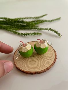 two green apples sitting on top of a piece of wood