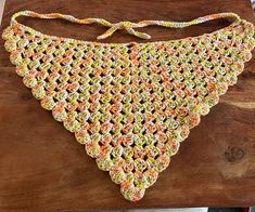 a crocheted bib on a wooden table