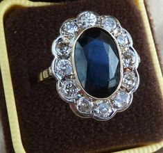 Date made: 1930'sSapphire content: 6ctDiamond content: 1.20ctMetal: 18ct white goldCondition: Excellent commensurate to it's ageFinger length: 21mmRing Size: UK S1/2   US/CAN 93/8  can be resizedA stunning original art deco ring This ring is simply breathtakingly beautiful.Catching the viewers eye is a wonderful 6ct oval cut sapphire. Measuring 13mmx9mm this has a mesmerising royal blue colour which has a rich depth too its colour, outstandingFlowing around the sapphire are twelve old cut diamon Vintage Sapphire Cluster Ring, Royal Blue Colour, Sapphire Antique Ring, Art Deco Sapphire Ring, Antique Rings Vintage, Antique Ring, Dope Jewelry, Royal Blue Color, Deco Ring