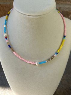 Multicolored seed bead necklace with shades of pink and blues. Accented with freshwater pearls. Bohemian Pearl Beaded Necklaces With Tiny Beads, Adjustable Pink Pearl Necklace With Colorful Beads, Pink Pearl Necklace With Tiny Beads, Pink Pearl Necklace With Colorful Round Beads, Pink Beaded Bohemian Pearl Necklace, Pink Bohemian Beaded Pearl Necklace, Bohemian Pink Beaded Pearl Necklace, Crystal Lake, Seed Bead Necklace