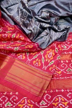 Just the kind of festive vibe that you would like to set - let's do it with the ikat silk. The hand-picked collection with a traditional geometric motif design on the body with ikat weaving work on the pallu and the golden zari border. It also sports an amazing double temple border which makes it unique. Color: A shade of grey and magenta color Technique: Amazing work of traditional tie and dye work on the whole saree with zari work Fabric: Ikat Silk Quality: IndyVogue's Assurance of Silk Mark Certified Fitted Ikat Print Saree For Festivals, Traditional Ikat Print Wedding Outfit, Red Ikat Print Sets For Festivals, Red Ikat Print Festival Sets, Navratri Ikat Print Red Sets, Ikat Print Traditional Wear For Weddings And Festivals, Bollywood Style Festive Ikat Print Traditional Wear, Festive Ikat Print Traditional Wear For Wedding, Bollywood Style Festive Traditional Wear With Ikat Print