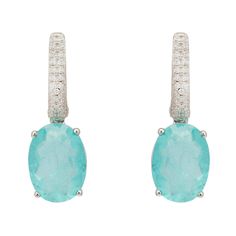 Looking for something special to add a little extra sparkle to your outfit? These Alexandra Oval Drop Earrings in Silver are simply gorgeous and will do just that! These beautiful earrings, handcrafted from 925 sterling silver, feature an oval Paraiba Tourmaline gemstone, accented with shimmering simulated Diamonds along the front edge of the latch back closure. They would be perfect to add a touch of colour and sparkle to any outfit, whether you're dressing up for a party or just adding a touch October Birthstone Jewelry, Drop Earrings Silver, Gemstone Drop Earrings, October Birthday, Paraiba Tourmaline, Mother Of Pearl Necklace, Tourmaline Gemstone, Stunning Earrings, Accessories Jewelry Earrings