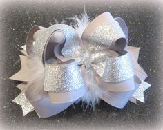 A Triple Layered Beautiful Grosgrain Ribbon Hair Bow full of Glitter~ Tall and full, this bow comes in a Mini 4.5" size and a Jumbo 6" size~ An Added Sparkle Overlay of Glitter and Center Spikes adds Glamour~ This Bow can be made with or without the middle Marabou Puff~ This Bow is made with Loop Bows of Silver and Silver Glitter, Bottom Accent Spikes of Silver and Silver Glitter Accents,  1 Flat Rate Shipping no matter how many bows you order~ And, Check out our shipping promotion for FREE SHIP Stacked Hair Bow, Hot Pink Hair, Big Hair Bows, Large Hair Bows, Toddler Hair Bows, Pink Hair Bows, Silver Headband, Glitter Hair Bows, Boutique Hair Bows