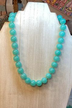 This beautiful Jade round necklace is a must for your jewelry box! It is classy and its color is very unique. The mint round beads are about 10mm or about 1/2 inch in diameter. The length is about 19 1/2 cm in length, or 16" long. The round, polished, smooth round beads, have a nice effect when reflecting the lights. I finished the necklace with a square shape gold plated toggle clasp, that makes it easy to put it on. And take it off as well! I added free earrings to go with it! The listing is f Elegant Jade Necklaces With Round Beads, Elegant Jade Beaded Necklace With 8mm Beads, Elegant Round Jade Beaded Necklaces, Classic Necklace With Large Beads For Gift, Classic Beaded Necklaces With 8mm Round Beads, Classic Adjustable Necklace With 8mm Beads, Jade Necklaces With Faceted Round Beads, Classic Jade Necklaces With Round Beads, Classic Jade Necklace With Round Beads