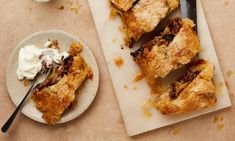 two plates with pastries on them next to a bowl of whipped cream and spoon