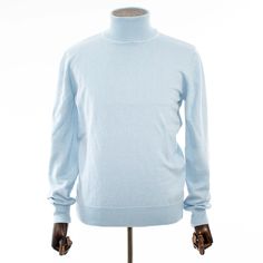 Slip into comfortable designer stylings in this handsome long-sleeved turtleneck with a traditional ribbed cuff design for versatility when paired with casual or semi-formal outfits. Formal Fitted Solid Color Sweater, Classic Spring Turtleneck Sweater, Classic Turtleneck Sweater For Spring, Spring Turtleneck With Ribbed Cuffs And Long Sleeves, Blue Fitted Turtleneck Sweater, Fitted Blue Turtleneck Sweater, Fitted Blue Turtleneck For Winter, Classic Solid Color Turtleneck Polo Sweater, Blue Fitted Cashmere Sweater