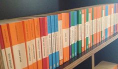 a bookshelf filled with many different colored books