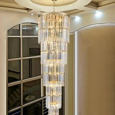 a chandelier hanging from the ceiling in a living room