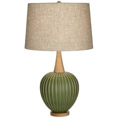 a green lamp with a beige shade on it