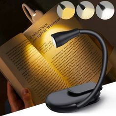 a person is reading a book with a lamp on top of it and three lights above the book