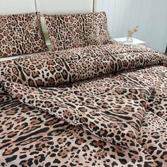 a leopard print bed spread with matching pillows