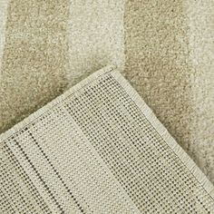 a close up view of a rug on the floor with it's edge missing