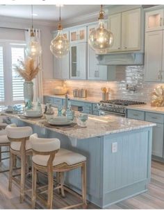 a large kitchen with blue cabinets and white counter tops is featured in this postcard