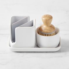 a set of kitchen utensils sits on a marble countertop next to a cup holder