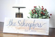 a wooden sign that says the schipers est 2016 on it next to a potted plant