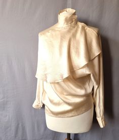 - Vintage Fendi365 blouse in cream - Lighweight cream colored satin. There is no materials label, could be silk or synthetic - Interesting bib collar - High Neck, to be closed on the shoulder with buttons - Raglan sleeves - French seams throughout, really well made - Label says: Fendi 365 by Contir Roma - This could be a fantastic piece for a vintage wedding outfit or wedding reception - combine with pants or a skirt! Condition: There are some very small and light marks in several areas of the b How To Make Labels, Bib Collar, French Seam, Cream Beige, Vintage Tops, Wedding Outfit, Raglan Sleeve, Vintage Wedding, Cream Color