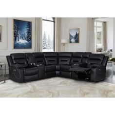 a large black sectional sofa with two recliners in front of a painting on the wall