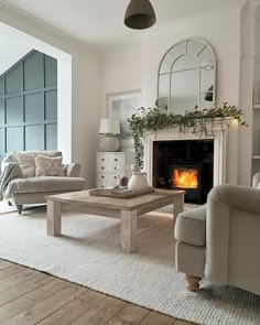 a living room filled with furniture and a fire place in the middle of a room