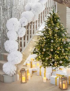 a decorated christmas tree in front of stairs