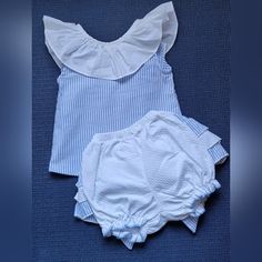 Lovely Two-Piece Outfit Consisting Of Top And Diaper Cover In 100% Cotton~ Sleeveless Blue And White Stripe Top Has White Ruffle Collar~ Two Button Closure In Back, With Bow Accent~ White Diaper Cover With Large Bow And Ruffles In Back, Blue And White Striped Accents~ Size 3-6 Months Made In Spain~ New Without Tags~ White Cotton Sets With Ruffles, White Cotton Ruffled Sets, White Ruffled Cotton Sets, Cotton Sleeveless Set For First Birthday, White Ruffled Playtime Sets, Blue Summer Sets For First Birthday, Blue Sets For First Birthday In Summer, Casual White Sets For First Birthday, White Sleeveless Sets For Playtime