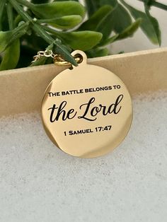 A beautiful 16K gold plated necklace engraved with "The Battle belongs to The Lord Bible Verse Gold Necklace, Christian Gifts, Scripture Jewelry, Personalized Quote Necklace, 1 Samuel 17:47 Charms are gold plated over stainless steel. Plated jewelry is a wonderful, affordable way to add a sophisticated look to your wardrobe, with the look of real gold. It is also an excellent choice for people with sensitive skin. CARE TIPS: Avoid contact with perfumes, body oils, and other chemicals, including Meaningful Gold Necklace For Personalized Gift, Meaningful Personalized Gold Necklace, Personalized Gold Necklaces, Meaningful Gold Jewelry With Engraving Option, Meaningful Gold Pendant Necklace, Gold Jewelry With Engraving Option, Inspirational Personalized Gold Jewelry, Gold Nameplate Necklace With Engraving Option, Inspirational Gold Pendant Jewelry