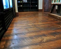 a living room with wood floors and a television