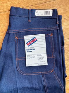 Rare deadstock vintage late 70's early 80's Big Mac industrial jeans. Classic painter pant style in dark denim with orange stitching. Wide pockets with lower side narrow tool pocket and hammer loop. Wide leg with slight taper. Features copper rivets and logo embossed snap at crotch. Heavy duty brass YKK zipper. 14+ ounce denim 64% cotton 36% polyester distributed by JCPenney new with tags size 36" waist 35-37"length. Vintage Straight Leg Jeans With Contrast Stitching, Painter Pants, Painters Pants, Big Mac, Ykk Zipper, Pant Style, Pants Jeans, Dark Denim, Jeans Pants