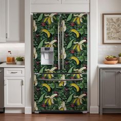 a refrigerator covered in bananas and other tropical fruit design wallpaper next to a kitchen counter