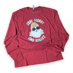 This listing is for a READY-TO-SHIP long sleeve t-shirt: - XL - Cardinal Red - Groovy Santa DTF decal front XL Measurements Width: 24" Length: 31" Look no further for the best ultra-soft long sleeve apparel. Reminiscent of peach fuzz, it's luxe velvety texture makes this a premium soft shirt. FABRIC AND CARE - Sueded Jersey - 60% Combed Ring-Spun Cotton, 40% Polyester - Classic fit - Runs true to size Notes: - Each shirt is made to order and printed by us via DTF (direct to film screen print tra Clothes Gender Neutral, Human Dog, Christmas Pullover, Neutral Christmas, Santa Shirt, Matching Mom, Mama Tee, Santa Shirts, Xmas Shirts