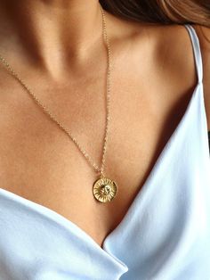 This 18kt gold-filled sun medallion pendant is sure to shine brightly on all who wear it. Featuring a beautiful sun on this coin, this necklace is the perfect everyday statement of optimism and abundance. 🌞 Gold chain length measures 20-22inches and is adjustable. Medallion Necklace Aesthetic, Gold Medallion Necklace With Sun Design, Yellow Gold Medallion Necklace With Sun Design, Sun Medallion, Gold Medallion Necklace, Etsy Promotion, Gold Medallion, Coin Pendant Necklace, Gold Sun