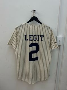 90s majestic jersey. deadstock. NWOT. new york yankees creme colorway w/ navy pinstripes. custom yankee blue back graphic. in excellent, unworn condition. made in USA. legit. legitvintage.etsy.com itslegitvintage on instagram Varsity Jersey With Three Stripes For Baseball Season, Collegiate Three Stripes Baseball Jersey, Collegiate Baseball Jersey With Three Stripes, Three Stripes Jersey For Streetwear, Fitted Baseball Jersey For College Sports Season, Fitted Baseball Jersey For Baseball Season, Three Stripes Jersey For Sports Season Streetwear, Three-stripes Jersey For Sports Season Streetwear, Streetwear Jersey With Three Stripes For Sports