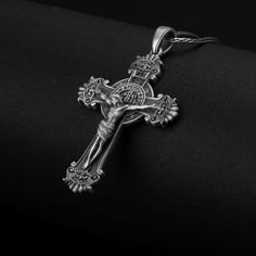 a silver cross on a black background