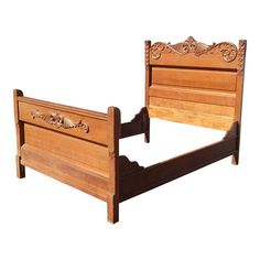 a wooden bed frame with intricate carvings on the headboard and foot board, against a white background