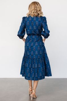 Your new favorite midi for any occasion Deep blue base that pulls topaz with blue and black floral print Cotton material has no stretch Notched V-neckline Functional loop buttons down bodice Mid-length sleeves with singular loop buttons at cuffs Adjustable drawstring waist Single-tiered midi skirt Lined bodice, unlined skirt and sleeves Self: 100% Cotton, Lining: 100% Polyester Fit runs big, we recommend sizing down Trina is 5'6, cup size 32D, size 2 and is wearing size XS Tiered Midi Skirt, Mid Length Sleeves, Black Floral Print, Cup Size, Blue And Black, Favorite Dress, Blue Print, Deep Blue, Mid Length