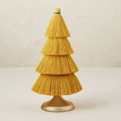 a yellow christmas tree made out of straw