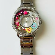 Selling This Watch With The Charms Inside. The Watch Itself Was $145 And Each Charm Was $6. Willing To Negotiate. Only Worn A Few Times. Silver Watch For Valentine's Day Gift, Silver Watches For Valentine's Day Gift, Silver Quartz Watches For Valentine's Day, Silver Valentine's Day Gift Watches, Valentine's Day Gift Watch With Round Dial, Valentine's Day Gift Watches, Gift Watches With Diamond Hour Markers And Round Dial, Diamond Watch With Rotating Bezel, Round Dial For Gift, Gift Diamond Watch With Metal Dial And Round Shape