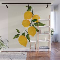 a wall mural with lemons and green leaves on it's branch in a living room