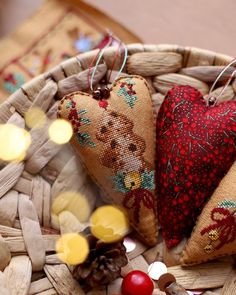 two heart shaped ornaments sitting in a basket