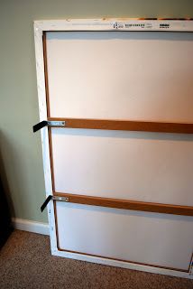 a white refrigerator freezer sitting inside of a kitchen next to a wall mounted tv