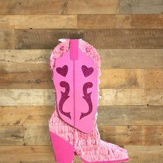 a pair of pink cowboy boots with hearts on them